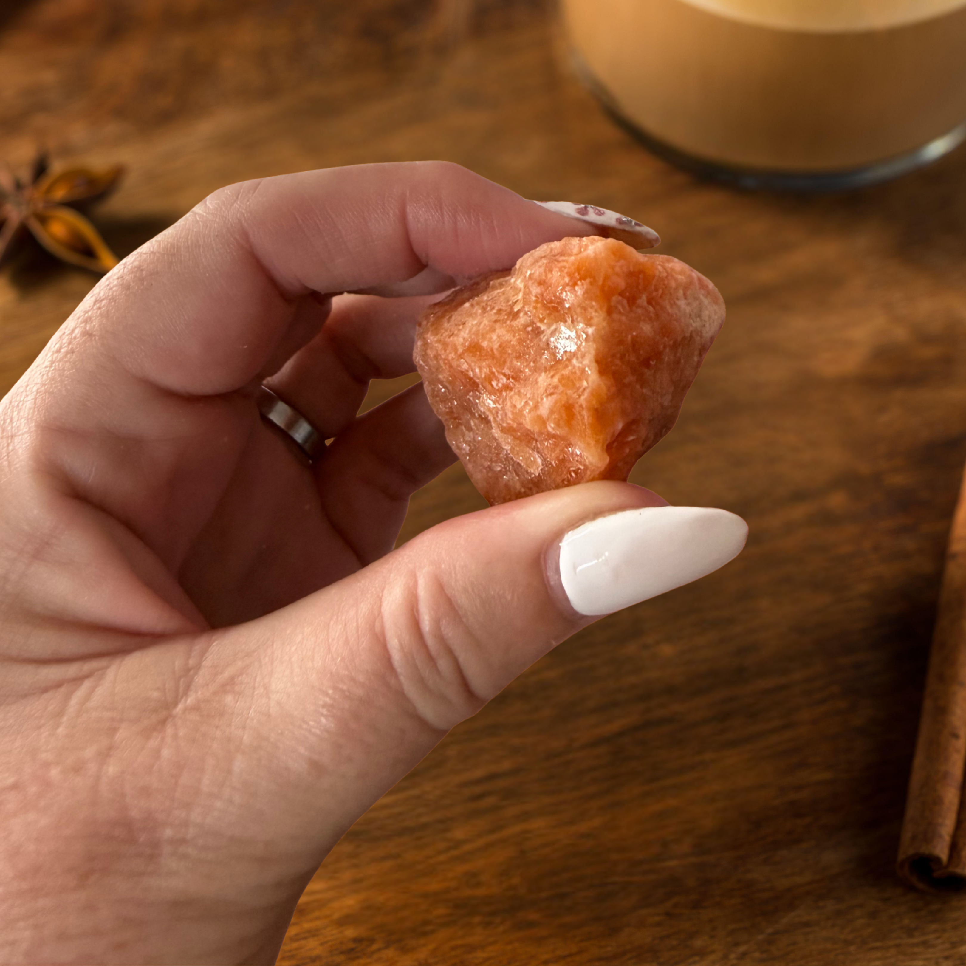 Close-up of a raw orange sunstone crystal from the Winter Mood Magic SAD & winter blues rescue kit, symbolising light and positivity.